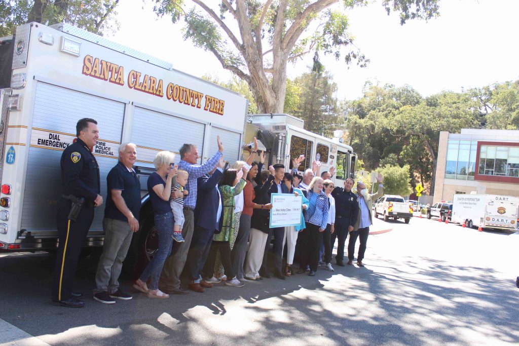 check presentation in front of fire truck