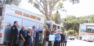 check presentation in front of fire truck