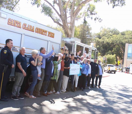 check presentation in front of fire truck