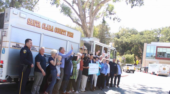 check presentation in front of fire truck