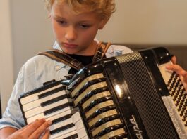 Boy must grow into this accordion