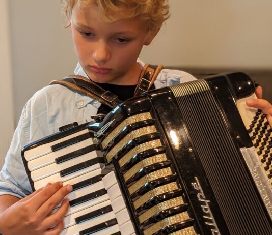 Boy must grow into this accordion