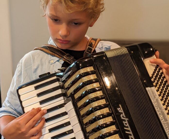 Boy must grow into this accordion