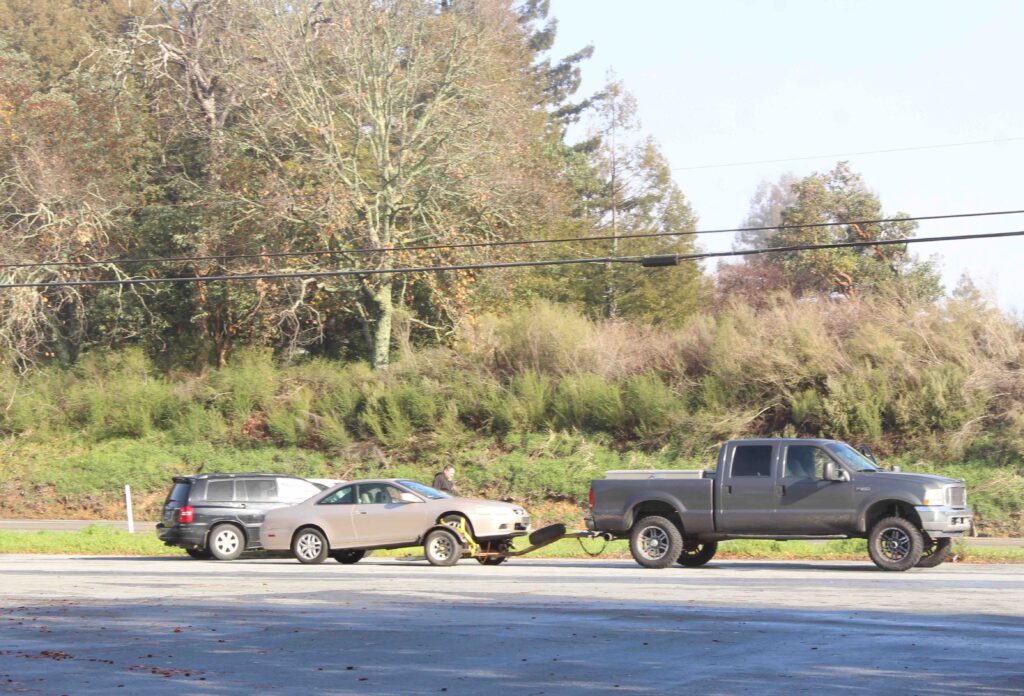 Truck towing a car.