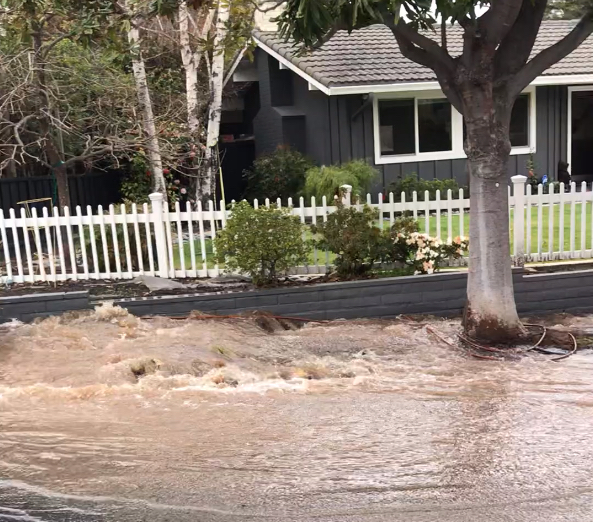 Rushing water in suburban neighborhood