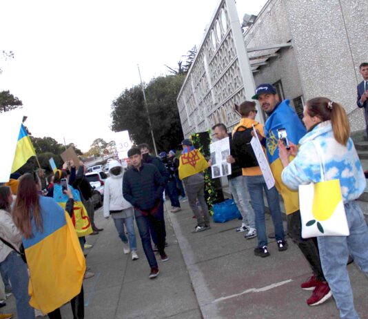 fans pass protesters