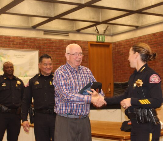 grad shakes chief's hand