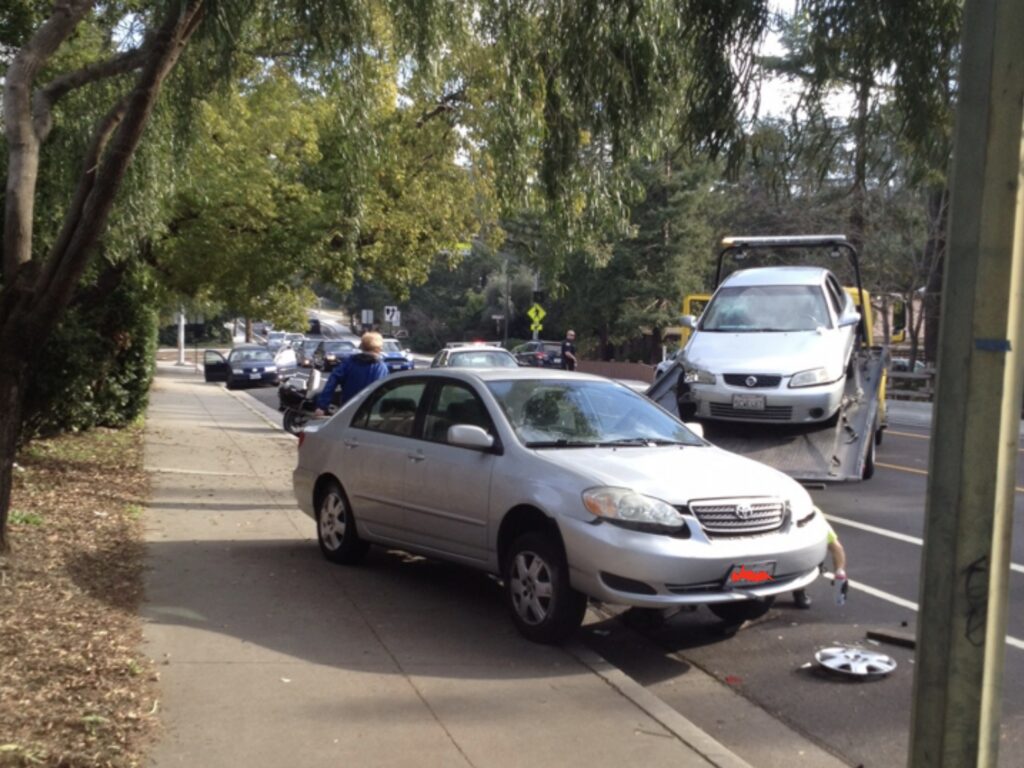 flatbed truck towing a car