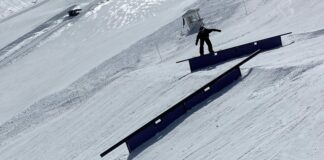 Snowboarder grinds a rail in the Sierras