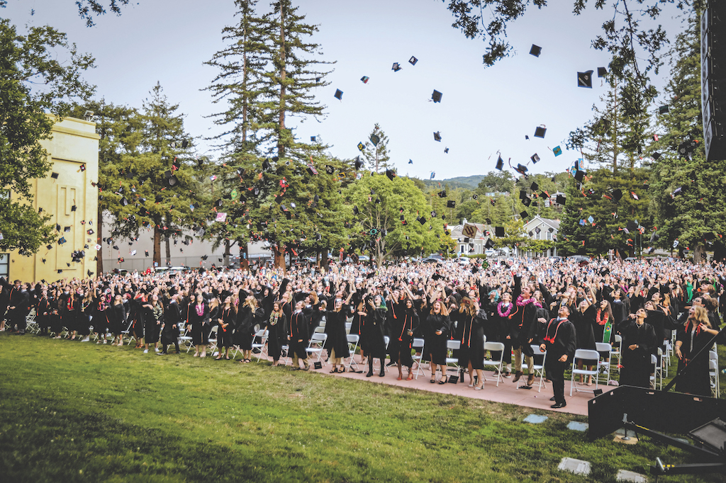 graduates throw caps into the air at Los Gatos High School.
