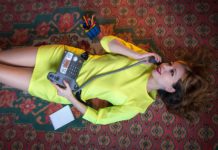 woman in a yellow dress speaks on a landline