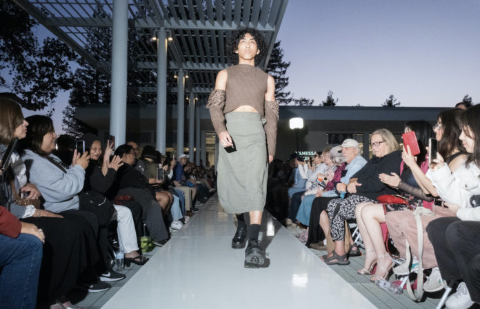 models walks on the runway in a cargo skirt and quilted top