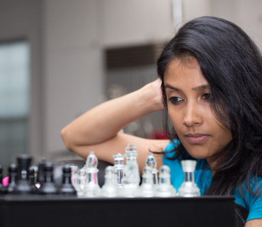 woman playing a chess game