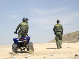 US Customs and Border Patrol agents on sand