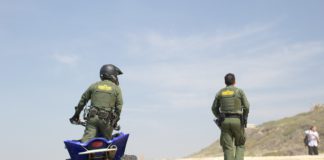 US Customs and Border Patrol agents on sand