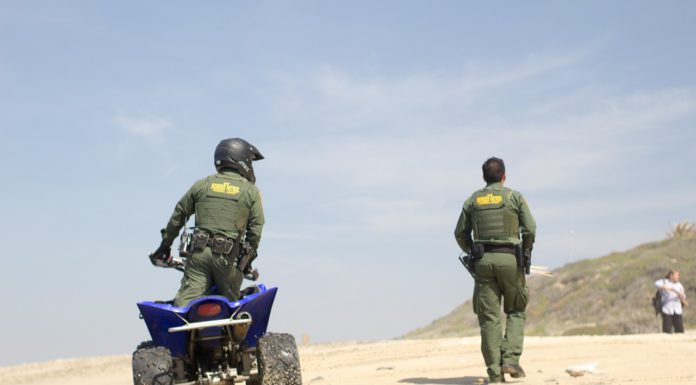 US Customs and Border Patrol agents on sand