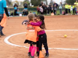 girls, softball players, hug