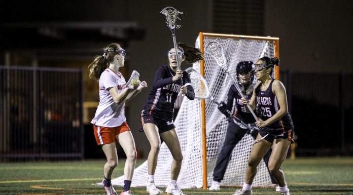 girls lacrosse by the net