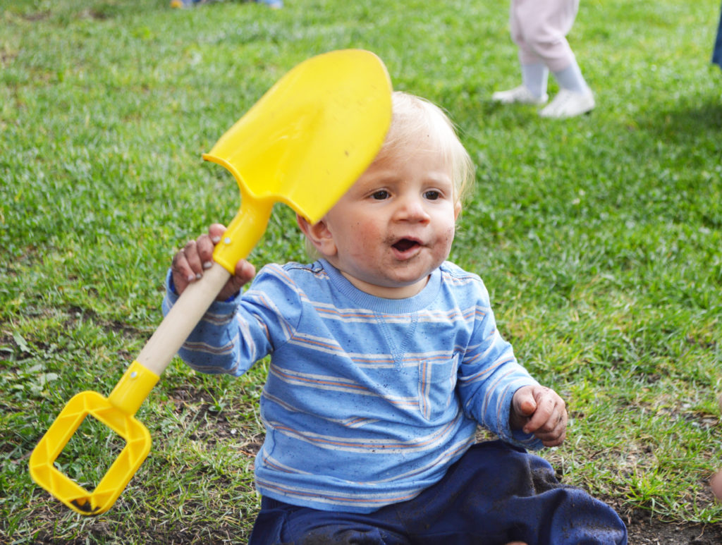 BABY HOLDS SHOVEL