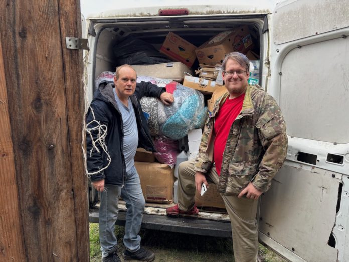 Aid packed in van van and two mission leaders