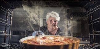 woman pulls baking from item