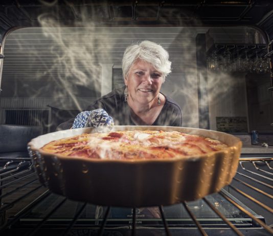 woman pulls baking from item
