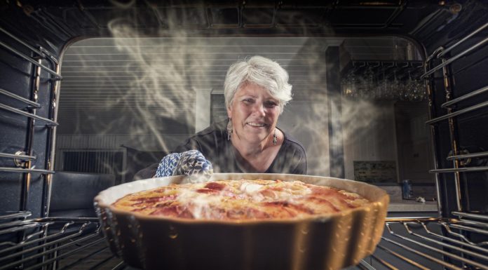 woman pulls baking from item