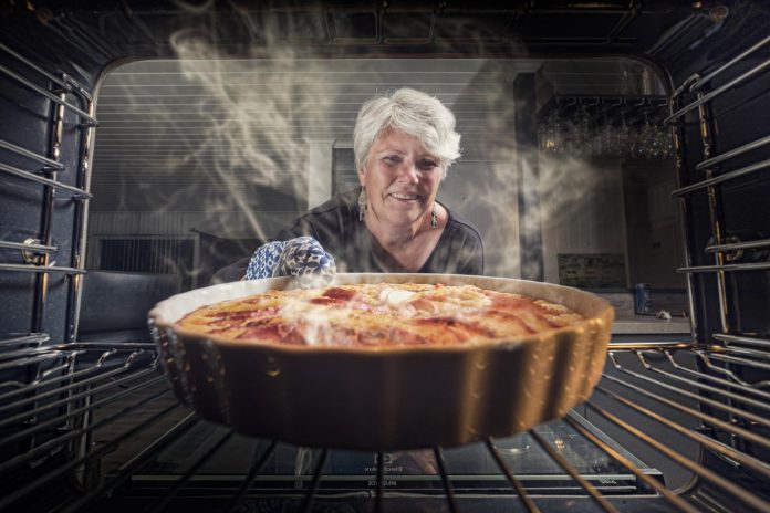 woman pulls baking from item