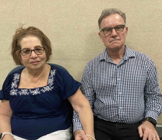 Jewish couple holds hands outside Council