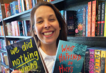 Woman holding up two books