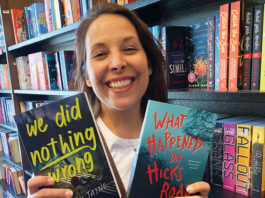 Woman holding up two books
