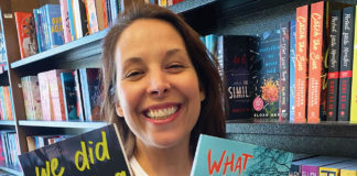 Woman holding up two books