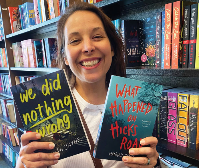 Woman holding up two books