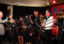 Older man conducting a group of younger musicians