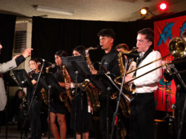 Older man conducting a group of younger musicians