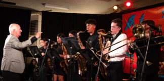 Older man conducting a group of younger musicians