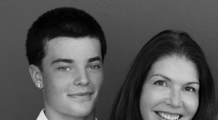 Young man and woman pose for photo