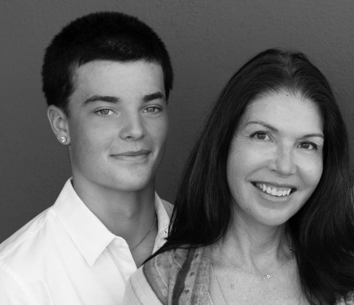 Young man and woman pose for photo