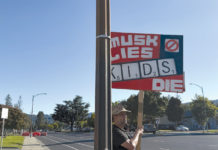 Sign that says "When Musk Lies Kids Die"
