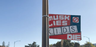 Sign that says "When Musk Lies Kids Die"