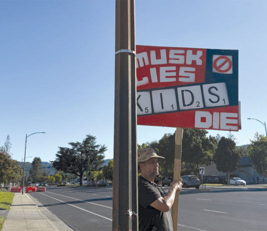 Sign that says "When Musk Lies Kids Die"