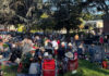 Crowd watching live music outdoors on a lawn