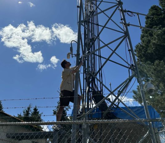 Daniel Roberts climbs a radio tower