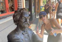 Mark Twain statue with woman giving a thumbs-up
