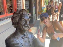 Mark Twain statue with woman giving a thumbs-up