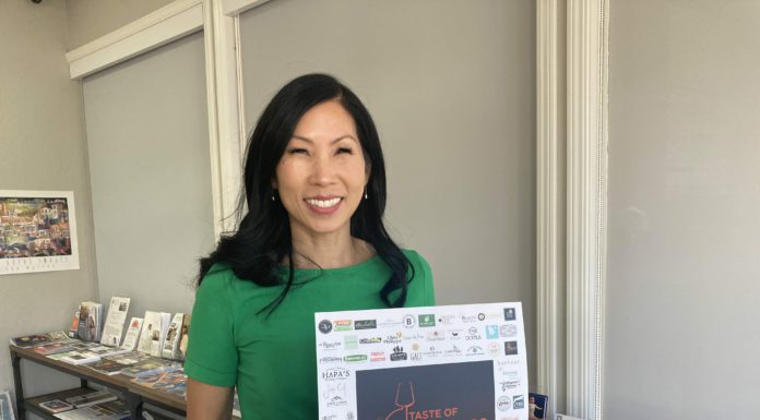 Taste of Los Gatos sign held by Lin