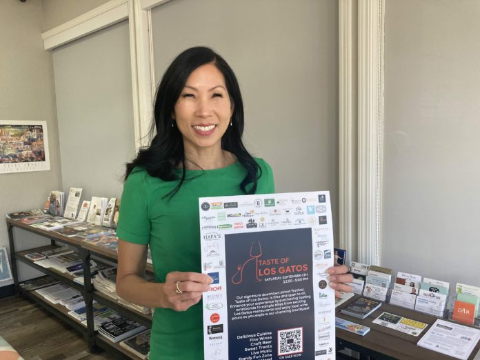 Taste of Los Gatos sign held by Lin