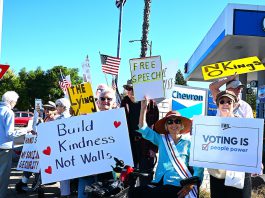 Protesters line both sides of Los Gatos Boulevard for “No Kings” rallies protesters