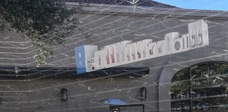 mirrored display case with fake urine and other smoke shop-style items