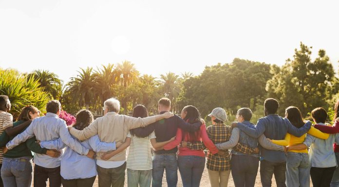 Author Diane Dreher on why we’re losing our sense of community stock image of a bunch of people together looking forward